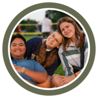 Photo of three students smiling for the camera